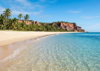Trecho de praia preservada sem resíduos e com água cristalina