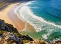 Por que as ondas do mar parecem sempre virar em direção à praia, mesmo quando o vento sopra de outro lado?